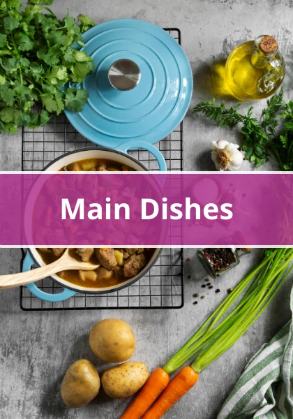 Blue Dutch oven with a hearty meat and vegetable dish surrounded by fresh carrots, potatoes, herbs, garlic, and olive oil.