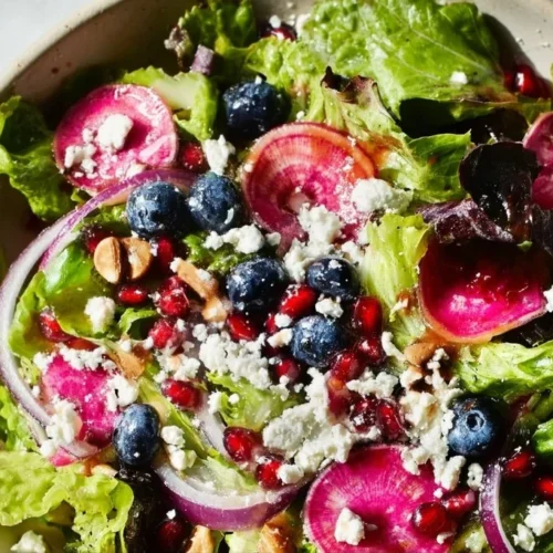 Blueberry Pistachio Spring Salad with fresh greens and vibrant toppings