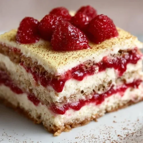 Delicious homemade Raspberry Tiramisu dessert with fresh raspberries and cream.