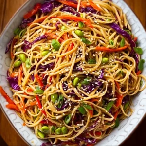 Colorful bowl of Sesame Noodle Salad with vegetables and sesame dressing