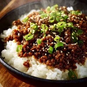 Korean Ground Beef Bowl garnished with vegetables and sesame seeds in a bowl