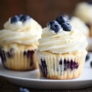 Delicious lemon blueberry cupcakes topped with lemon frosting and fresh blueberries